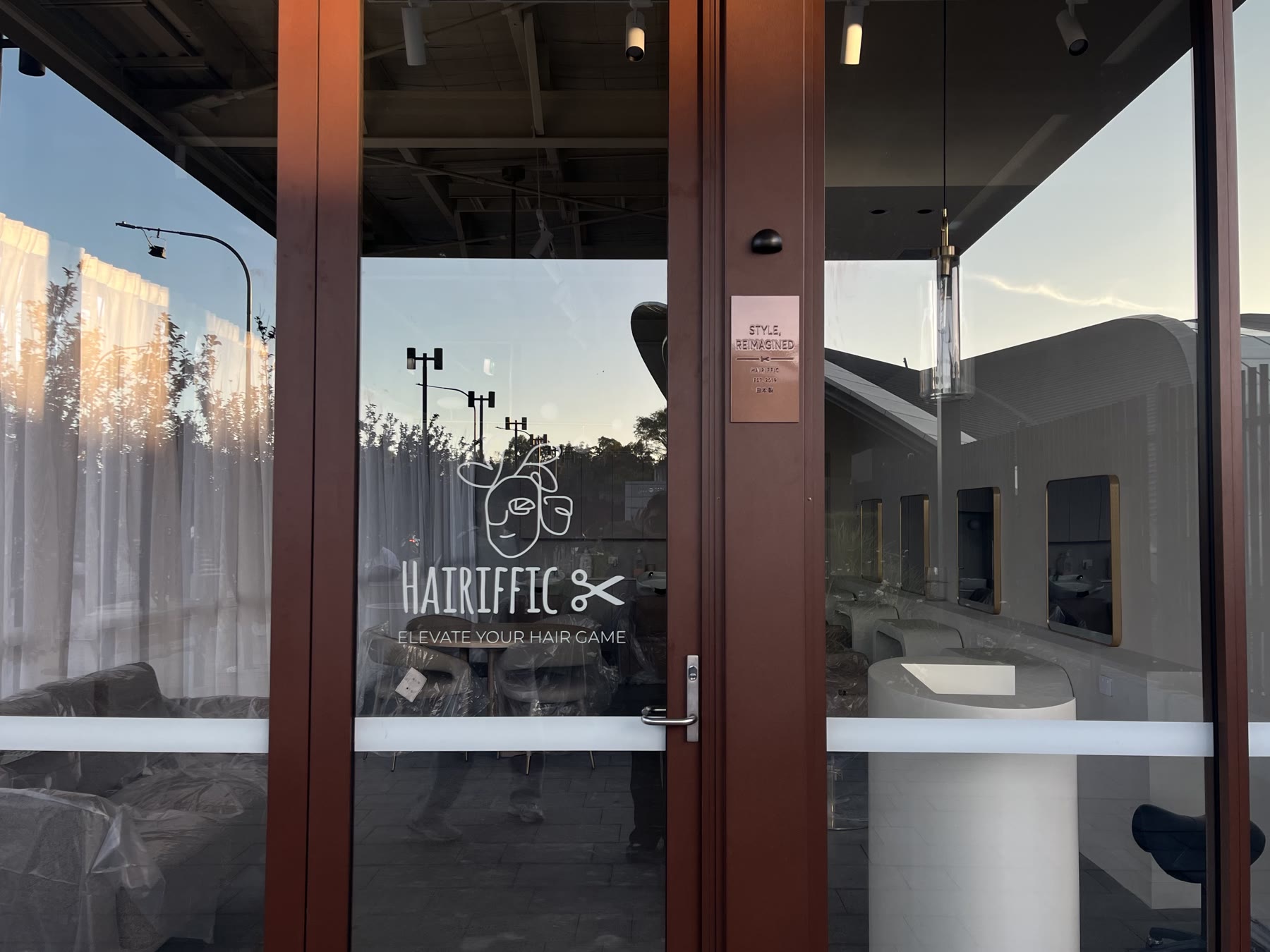 Hairiffic storefront glass door with the logo
